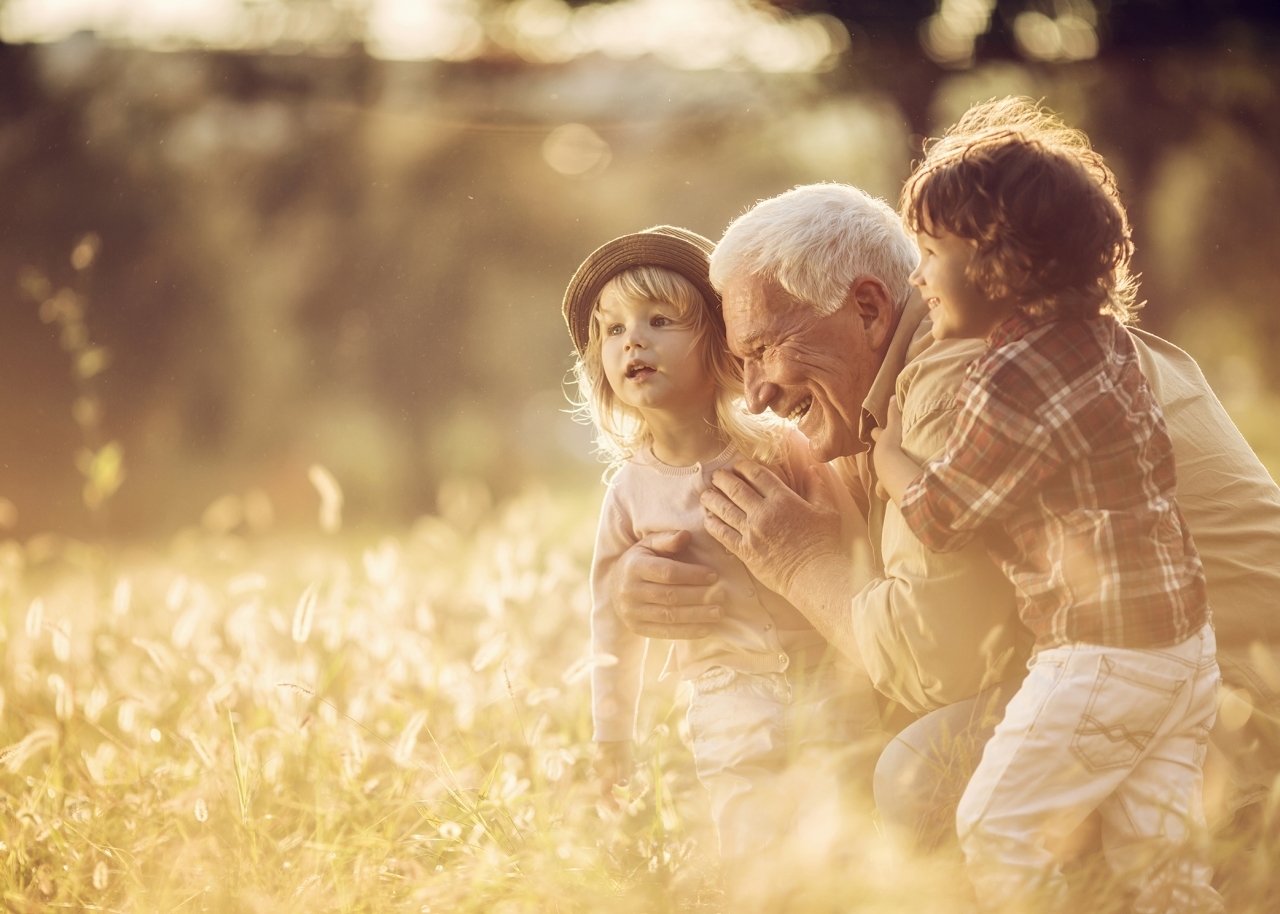 Close up of a playful grandfather playing with his grandchildren